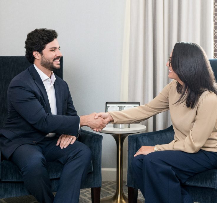 Dr. Caitlin Magraw shaking hands with a patient